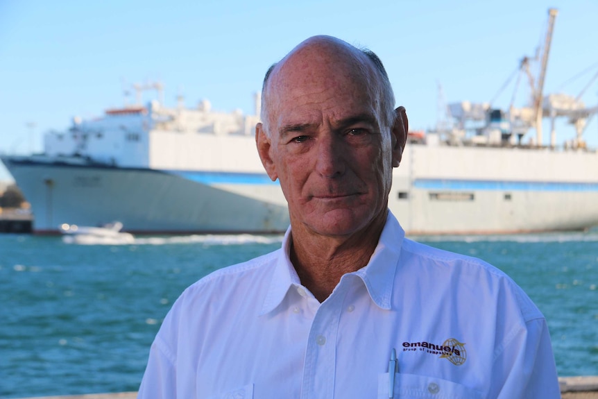 A shot of Graham Daws in front of the ship Al Messilah.