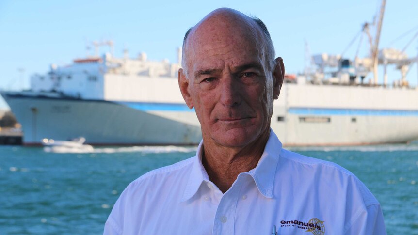 A shot of Graham Daws in front of the ship Al Messilah.