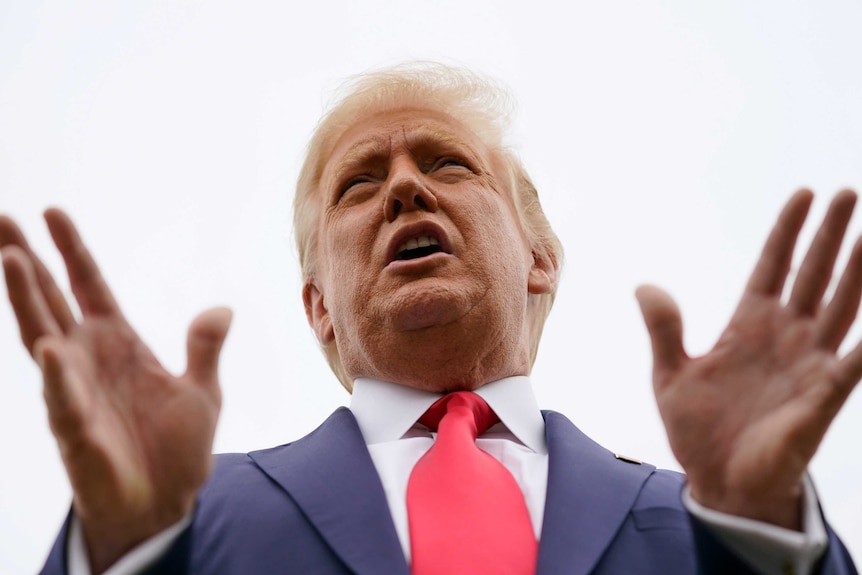 President Donald Trump speaks to the media before boarding Air Force One