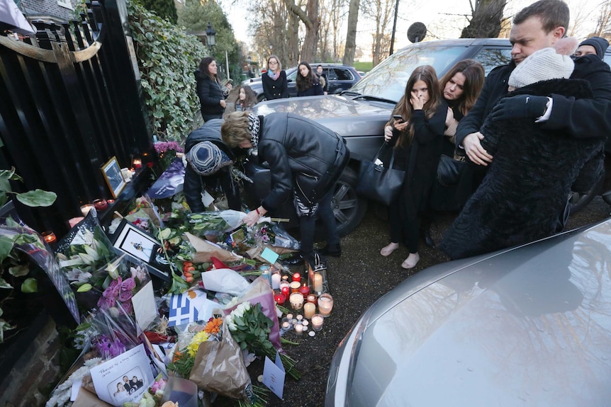Fans lay floral tributes at George Michael's London home