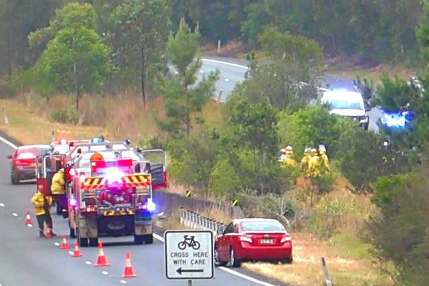 Emergency services attend crash scene on highway median strip