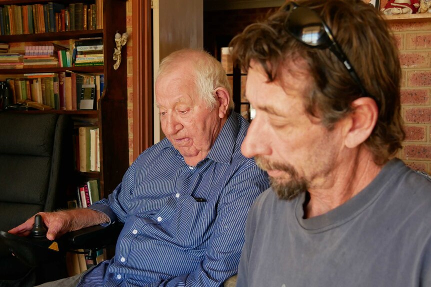 Picture of George and David Chadwick looking at family photo albums.