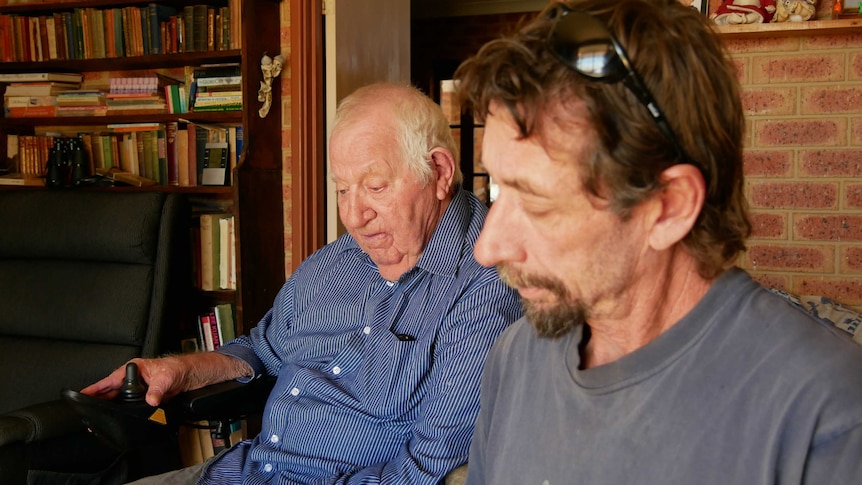 Picture of George and David Chadwick looking at family photo albums.