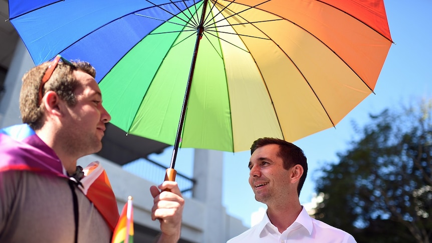 The LNP candidate for the seat of Brisbane Trevor Evans under umbrella.