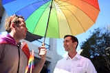 The LNP candidate for the seat of Brisbane Trevor Evans under umbrella.