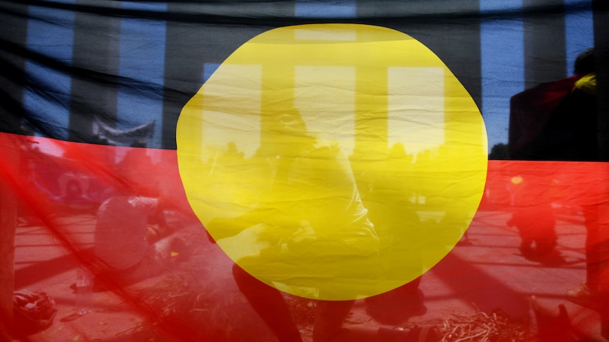 Looking through an Aboriginal flag at Parliament House