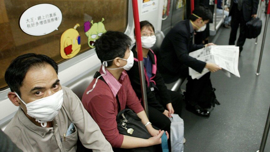 Commuters in Hong Kong wear face masks during SARS outbreak