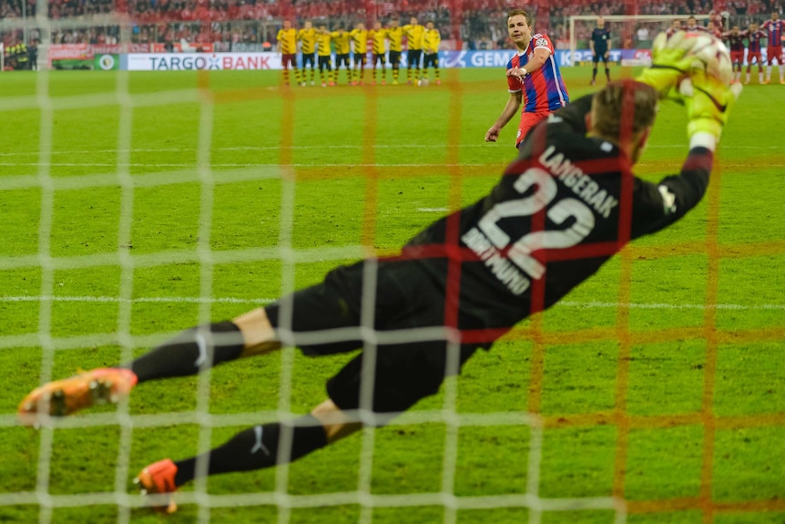 Mitch Langerak saves a penalty against Bayern Munich