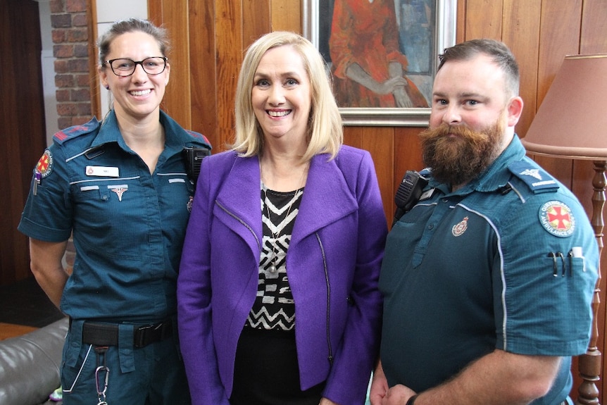 ABC TV Queensland weather presenter Jenny Woodward with paramedics, Melissa Rogers and John Sorban, who treated her.