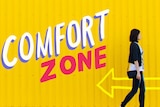 Woman walking against a yellow wall with the painted title 'comfort zone'.