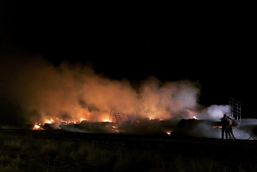 hay bales on fire on side of Landsborough highway