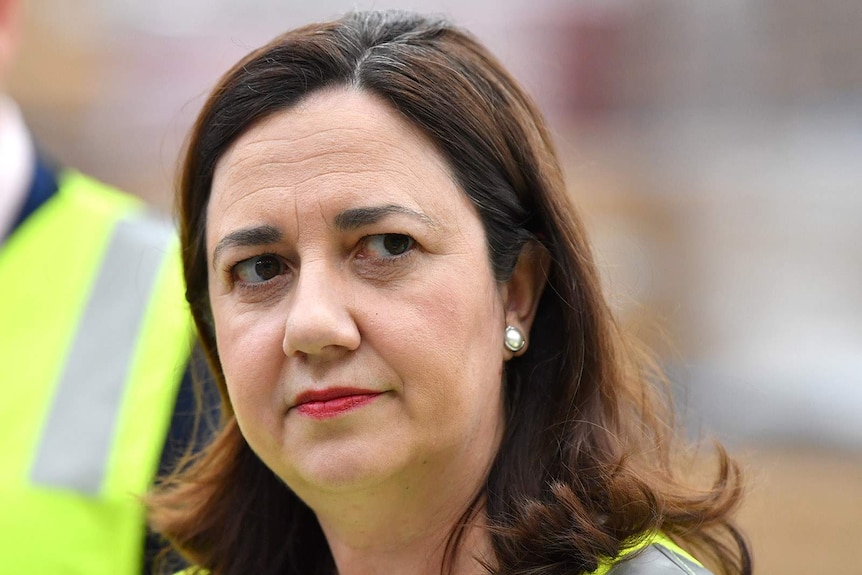 Queensland Premier Annastacia Palaszczuk looks towards the camera.