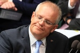 Scott Morrison leans back in his chair with a serious expression on his face