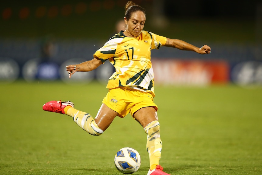 A Matildas player lines up the ball to kick with her right foot in Australia's match against Thailand.