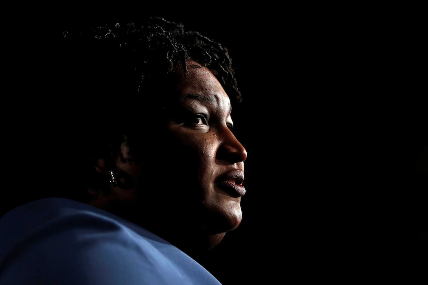 Stacey Abrams in profile looking serious