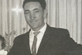 Black and white photo of a man in a suit.