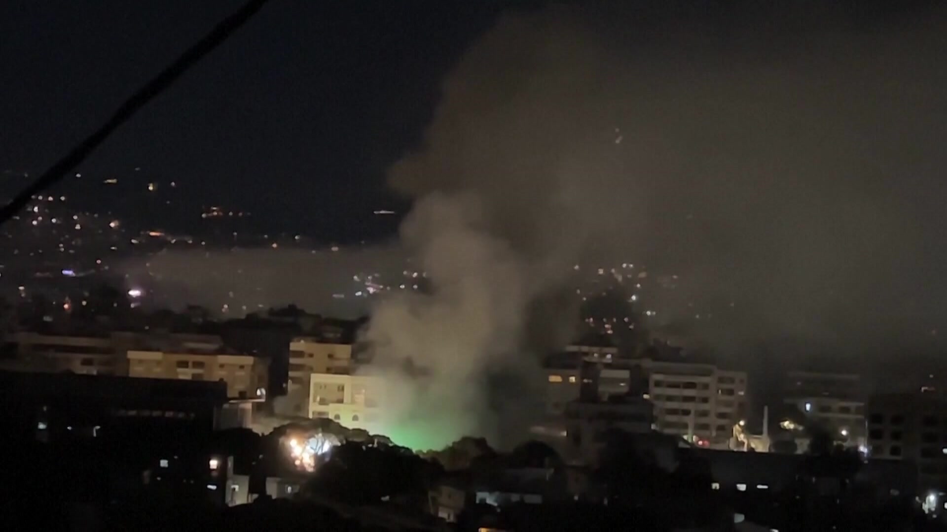 Plume of smoke billows from Beirut night skyline after an Israeli air strike.