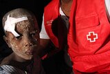 A nation suffers: a child receives aid at a Red Cross shelter
