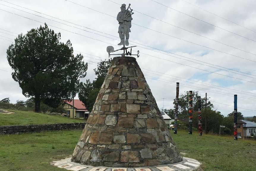 Maclean Cairn with the Chiefs tartan poles in the background.