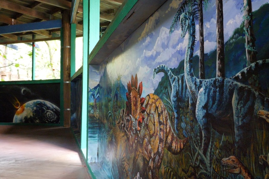 A mural with dinosaurs on a wall