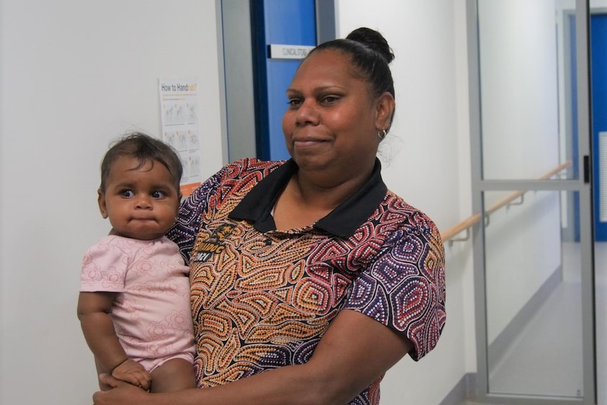 An Aboriginal woman holds her child