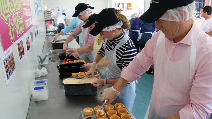 Volunteers helping to make strawberry sundaes