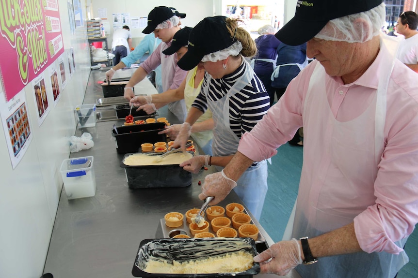 Volunteers helping to make strawberry sundaes