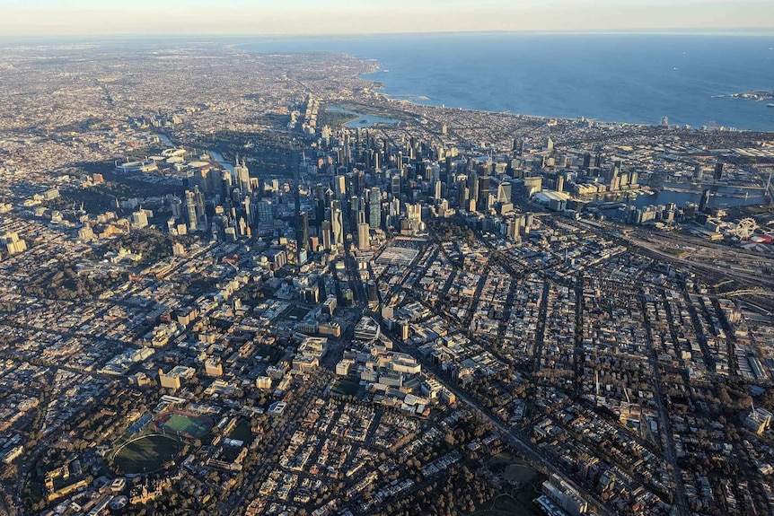 aerial shot of melbourne showing houses and city skyscrapers