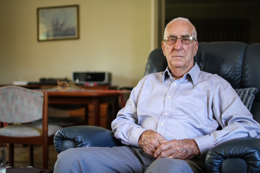 James Kerr from Melbourne at home sitting on his armchair.