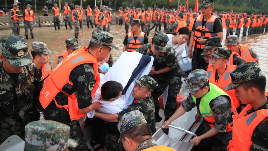 Chinese military move injured person wrapped in white