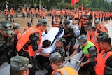 Chinese military move injured person wrapped in white