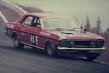 A red Ford Falcon GT-HO racing down the track at Bathurst in 1971.