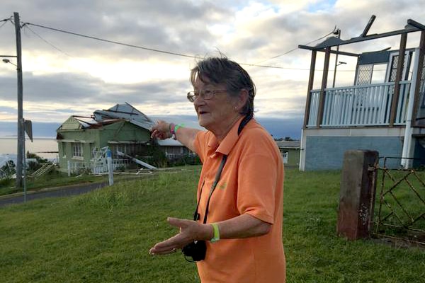 Yeppoon resident Kay Clark points out the damage after Cyclone Marcia
