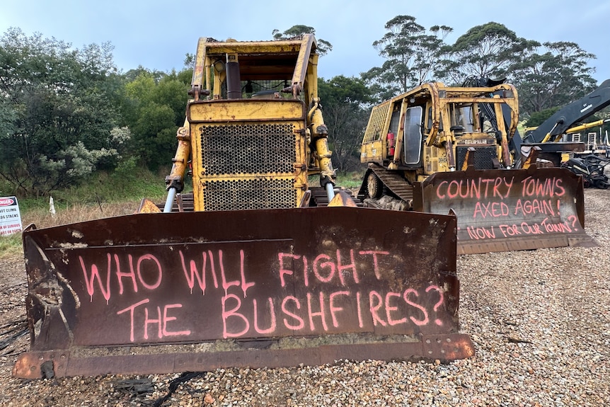 Two logging machines have been graffitied with the words "who will fight the bushfires?"