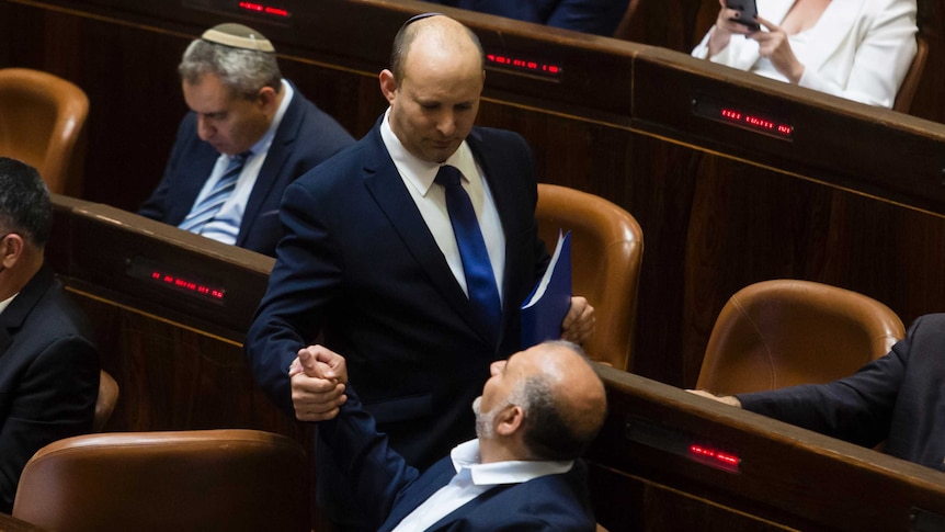 Israel’s first Orthodox Jewish Prime Minister, Naftali Bennett shakes hands with Mansur Abbas, leader of United Arab List party.