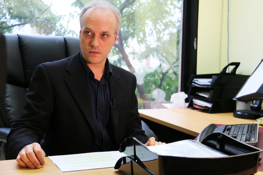 Dr David Pope at his desk.