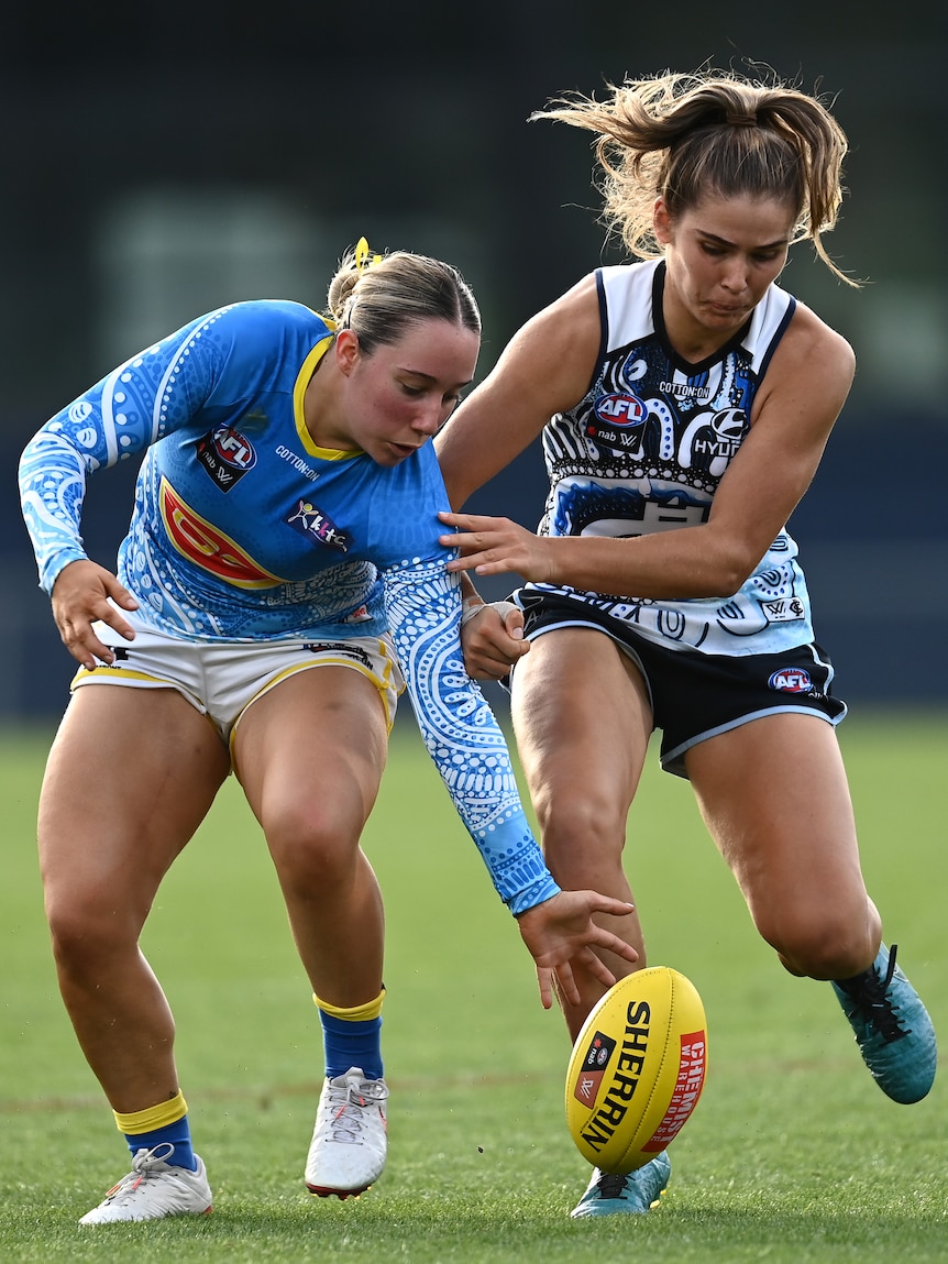 AFLW players Jacqui Yorston and Madeline Guerin compete for the ground ball