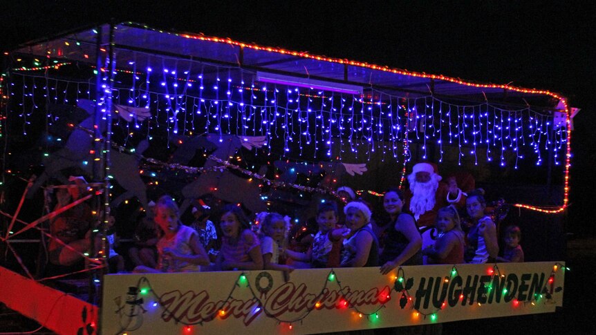 A six metre trailer which decorated with Christmas lights, Santa and children sit inside