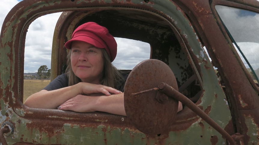 A woman in a rusted car