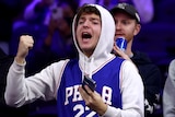 Philadelphia 76ers fans shout from the stands.