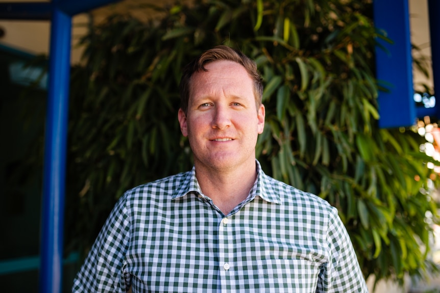 A man in a checked shirt. 