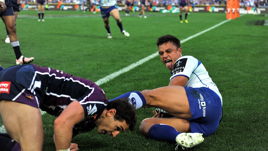 Sam Perrett (right) collides with Billy Slater after scoring a try.