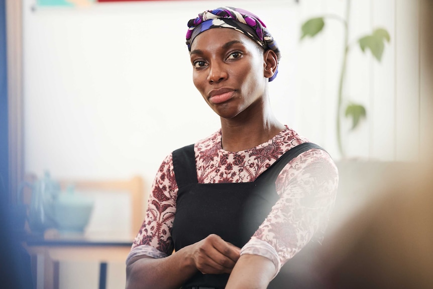 A scene from the TV series I May Destroy You with Michaela Coel sitting in a group therapy session