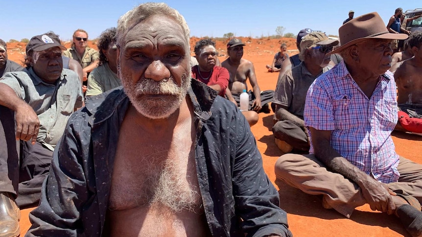 Ned Hargraves sits in a mob in Yuendumu.