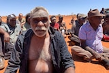Ned Hargraves sits in a mob in Yuendumu.