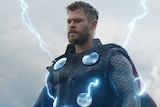 Colour still of Chris Hemsworth with lightning streaks emanating from his armour in 2019 film Avengers: Endgame.