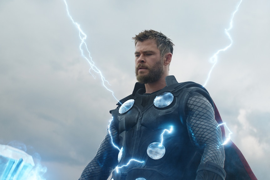 Colour still of Chris Hemsworth with lightning streaks emanating from his armour in 2019 film Avengers: Endgame.