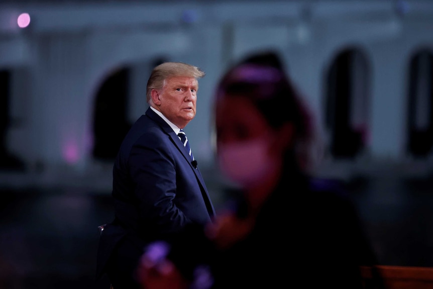 U.S. President Donald Trump looks on during a commercial break during a live one-hour NBC News town hall