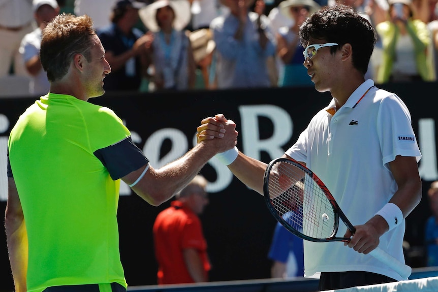 Hyeon Chung (R) shakes hands with Tennys Sandgren after winning their Australian Open quarter-final.