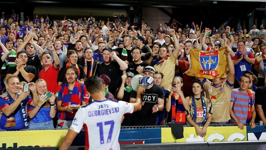 Daniel Georgievski of the Jets with waving fans